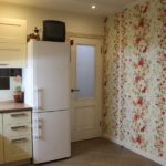 Photo of a kitchen with floral wallpaper