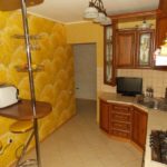 Yellow wallpaper in the kitchen with a corner set