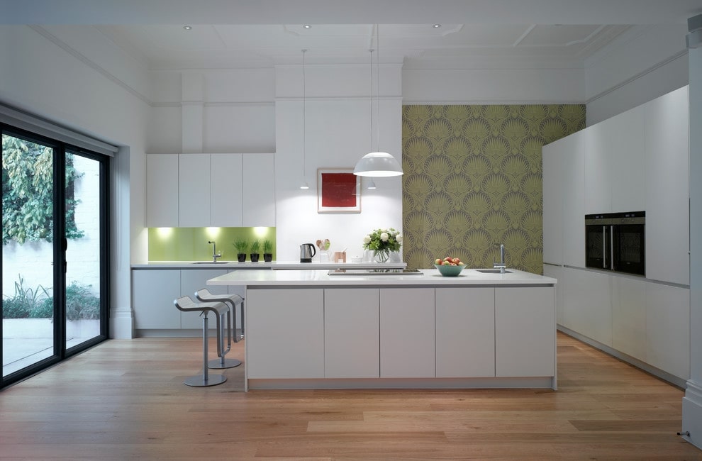 Green wallpaper with an ornament on the kitchen wall in a modern style