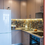 Small corner kitchen with fridge