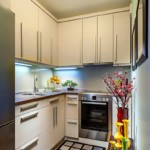 Narrow kitchen with cupboards to the ceiling