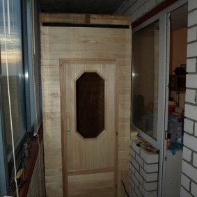 Small sauna on the balcony of a brick house