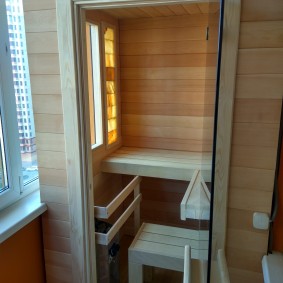 Interior of a small sauna on the balcony of a five-story building