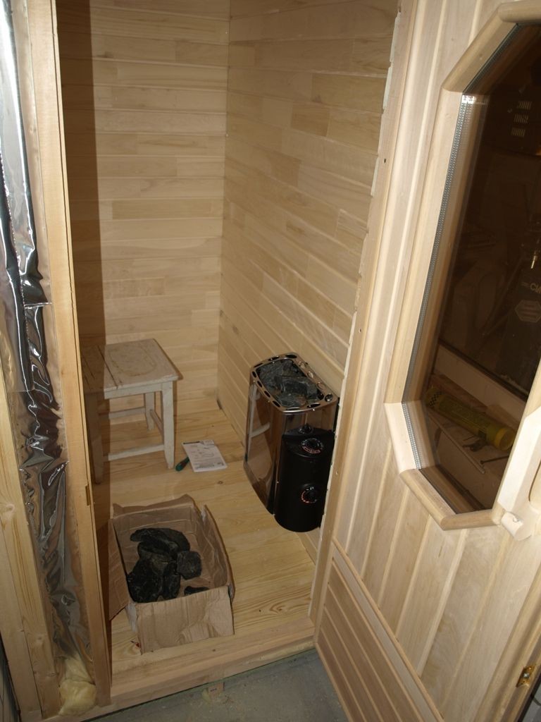 Compact stove-heater inside the loggia sauna