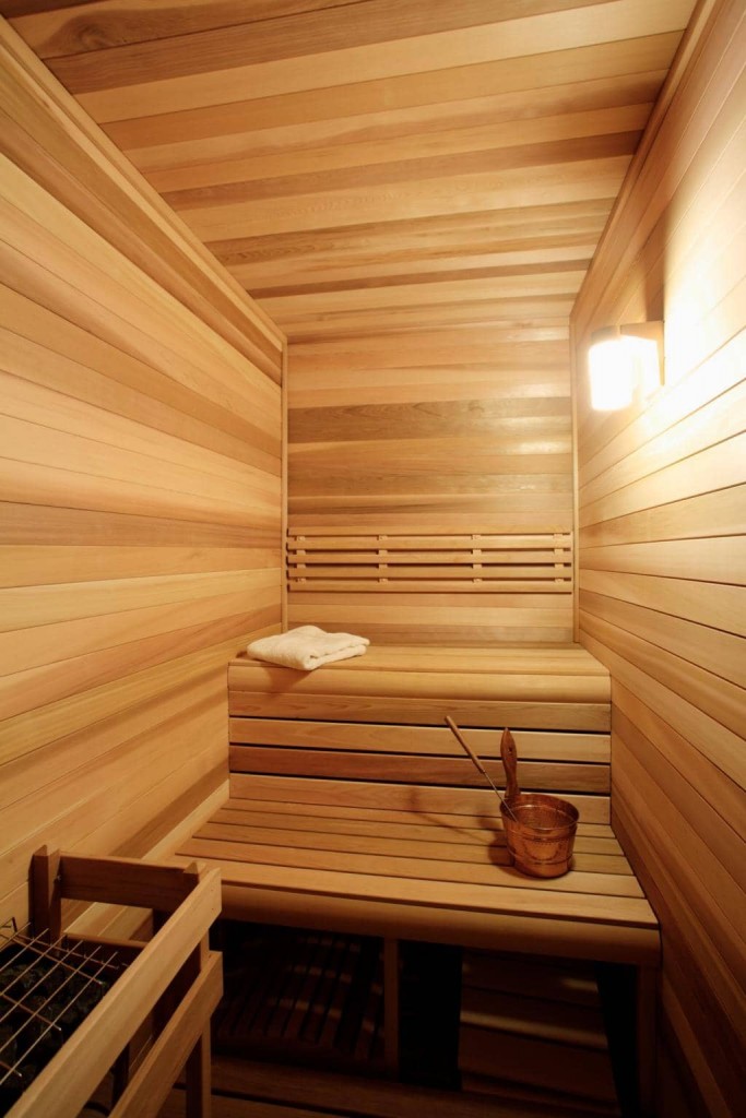 Shelves in a narrow steam room of a compact sauna