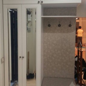 wardrobe with hinged doors to the entrance